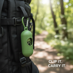 Green pet waste bag dispenser clipped to a backpack on an outdoor trail